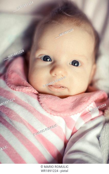 Portrait of baby girl in pink clothing