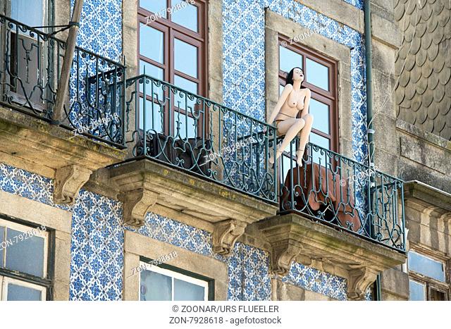 a naket women pupet on a balcony in Ribeira in the city centre of Porto in Porugal in Europe