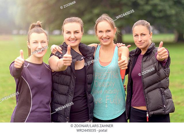 Four Athletic Women Friends Giving Thumbs Up