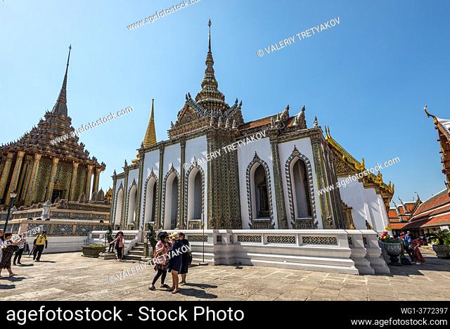 Bangkok, Thailand - December 7, 2019: Many tourists in the Temple of Emerald Buddha (Wat Phra Kaew) in Grand palace, Bangkok, Thailand