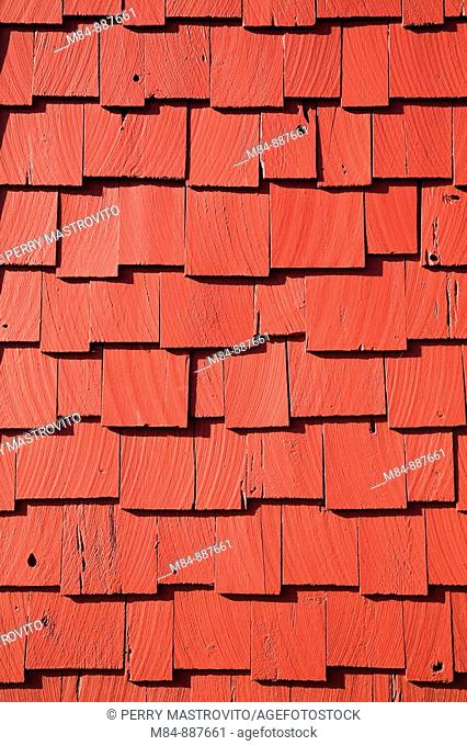 Close-up of red painted cedar shingles on the side of a garden shed, Montreal Botanical Garden, Quebec, Canada