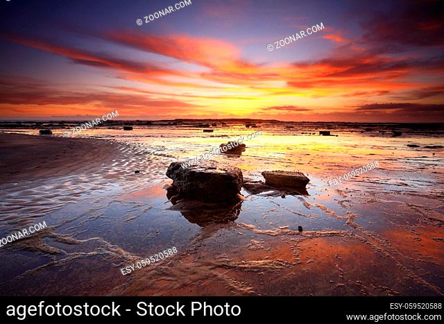 Vivid sunrise and reflections across Long Reef in Sydney's Northern beaches, Australia