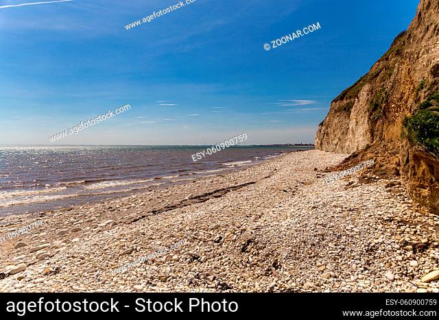 North sea coast with the pebble beach and cliffs of Danes Dyke near Bridlington, East Riding of Yorkshire, UK