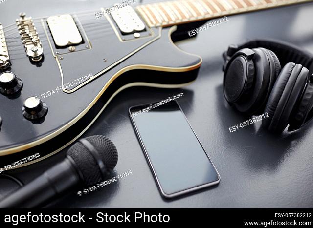 close up of bass guitar and smartphone