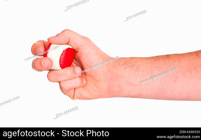 Closeup on white background of male hand with a red and white ball