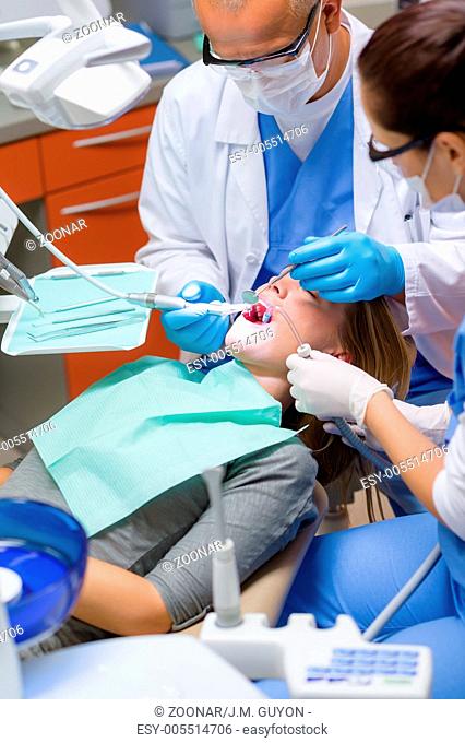 Woman at dentist surgery have teeth treatment