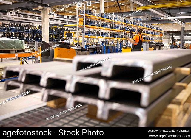 04 August 2021, Hamburg: An employee works on construction parts and intermediate products in a logistics terminal of Still, a manufacturer of forklift trucks