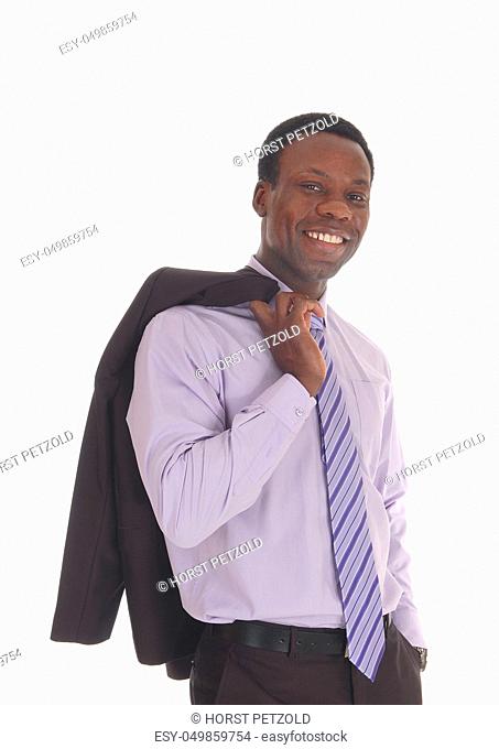 A happy and handsome African American man standing in a dress shirt and tie with his jacked over his shoulder, isolated for white background