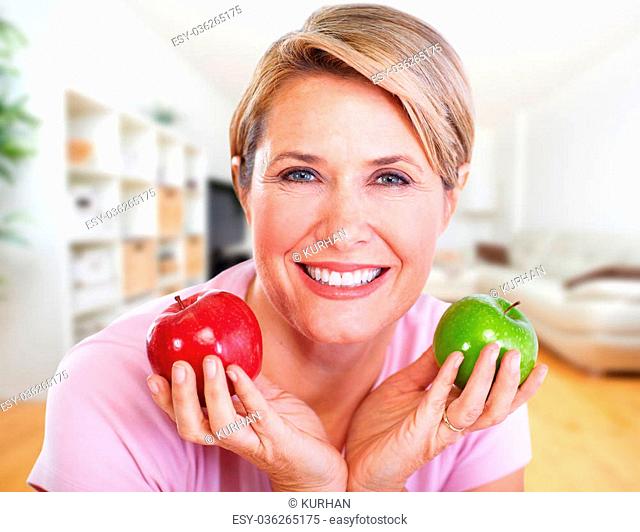 Senior smiling woman with apple. Diet and healthy weight concept