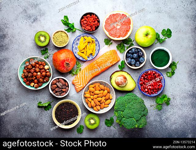 Selection of healthy products and superfoods: salmon, fruit, vegetables, berries, goji, spirulina, matcha, quinoa, chia seeds, nuts