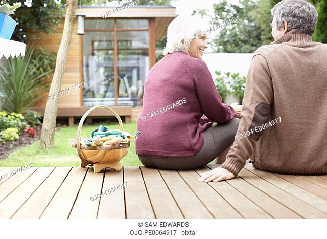 Couple sitting on backyard deck