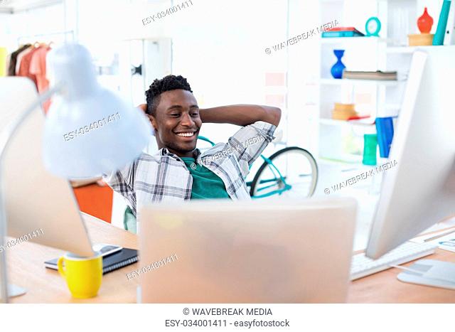 Male executive relaxing at his desk