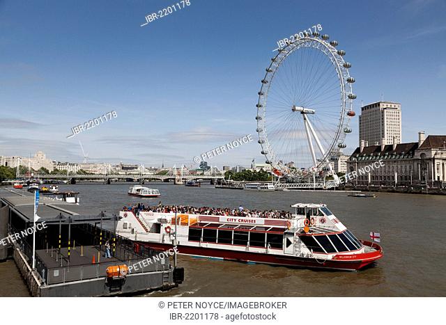 London Eye and a river cruiser on the River Thames, London, England, United Kingdom, Europe