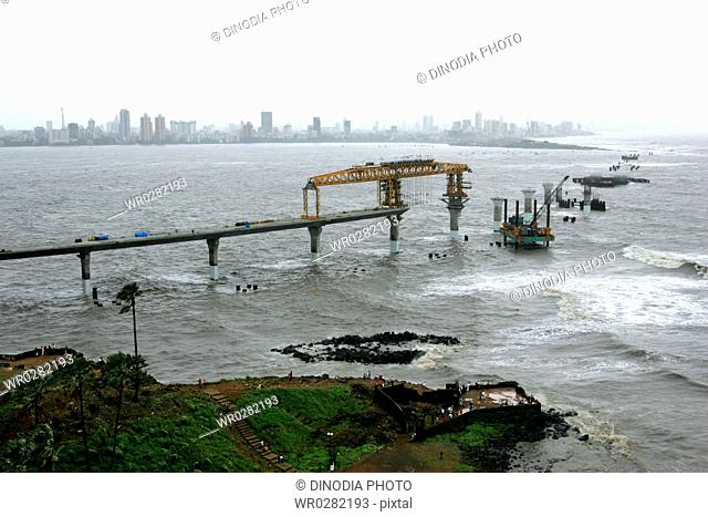 An aerial view of Bandra Band Stand and the construction site of the Bandra Worli Sea link on Arabian Sea , Bombay now Mumbai , Maharashtra , India