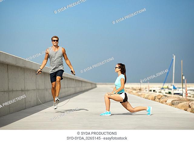 happy couple warming up on pier before training