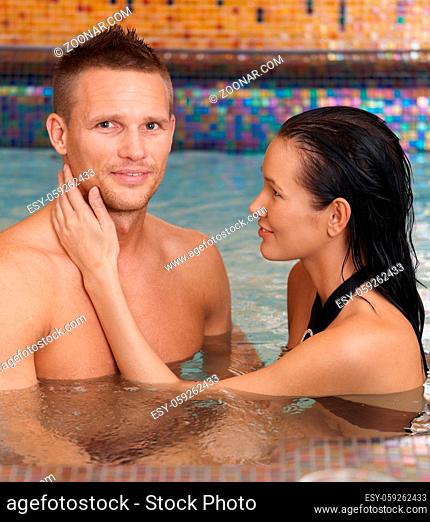 Happy couple on wellness program, relaxing in spa, woman caressing smiling man