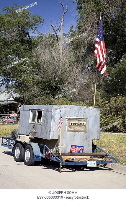 Antique trailer/camper for sale with American flag in Crawford Nebraska, Northwestern portion of state