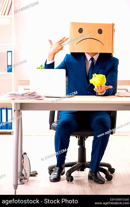 Unhappy man employee with box instead of his head