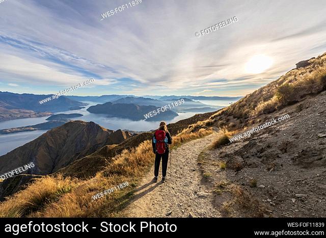 Woman hiking at Roys Peak, Lake Wanaka, New Zealand
