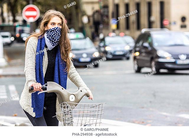 Woman riding a bicyle in a urban environment