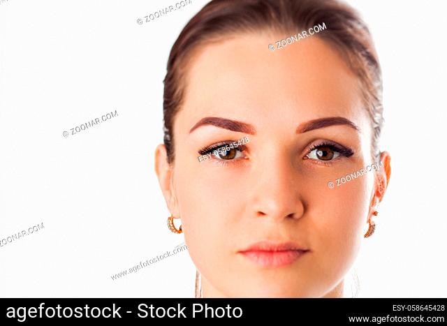 Portrait of beauty model with natural make up, formed eyebrows and long eyelashes over white backgound