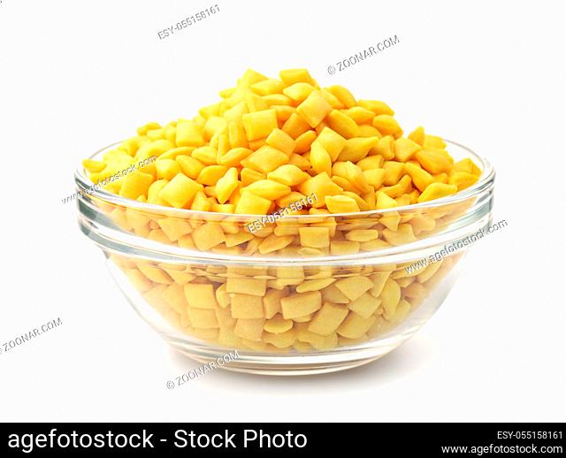 Glass bowl full of mini mandels croutons isolated on white