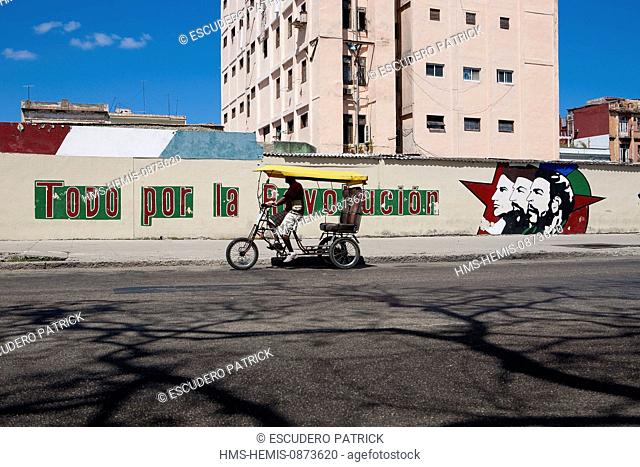 Cuba, Ciudad de La Habana Province, Havana, Centro habana District, bicy taxi and mural on the theme of revolutionary propaganda