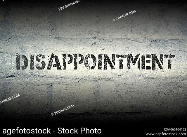 disappointment stencil print on the grunge white brick wall