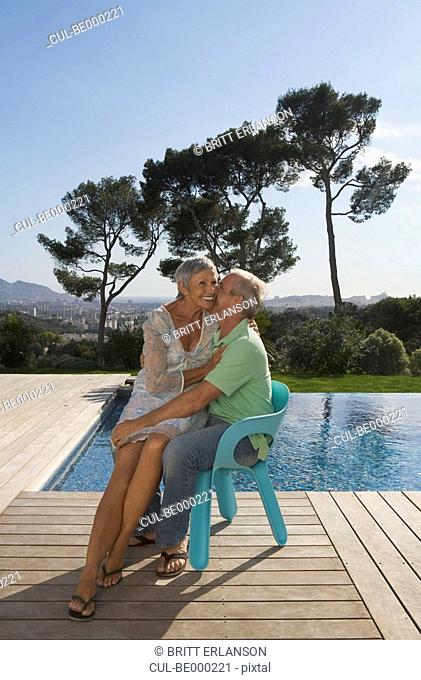 Older couple hugging on terrace