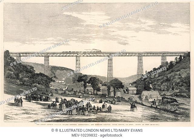 Victorian crowds gather and watch as a train passes along the Crumlin Viaduct in Wales, carrying the Newport, Abergavenny and Hereford Railway