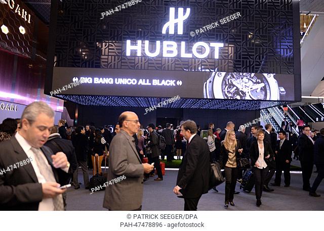 Fair visitors walk past the stand of watch manufacturer Hublot at the International watch and jewellery fair Baselworld 2014 in Basel,  Switzerland