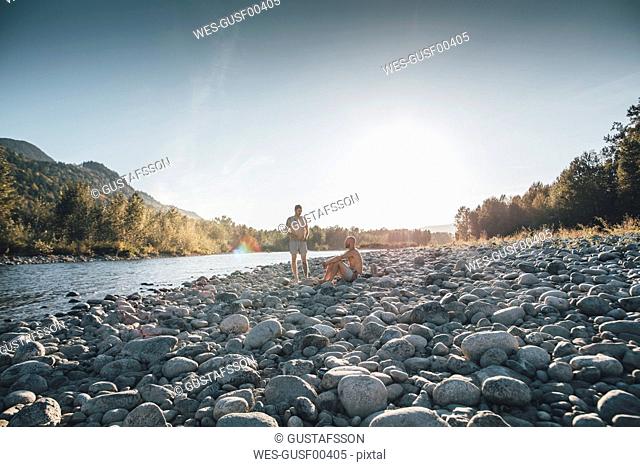 Canada, British Columbia, Chilliwack, two men resting at Fraser River