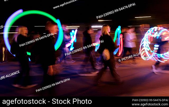 02 September 2023, Saxony-Anhalt, Dessau-Roßlau: Participants in a parade walk through the city with light elements. The two-day Bauhaus Festival will feature...