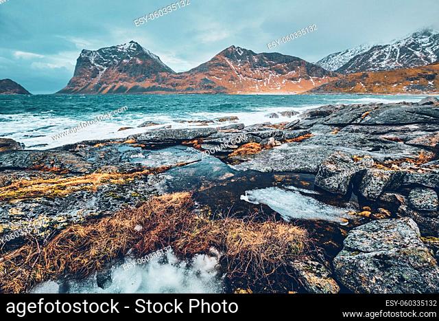 Rocky coast of fjord of Norwegian sea in winter. Lofoten islands, Norway
