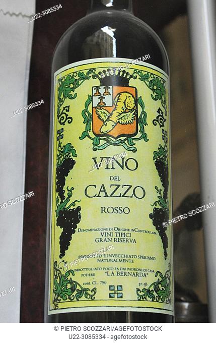 Turin, Italy: 'Vino del Cazzo' ('Fucked Wine') bottle from the window of an antique shop specialized in old erotic goods
