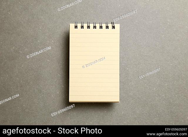Empty notepad on gray background