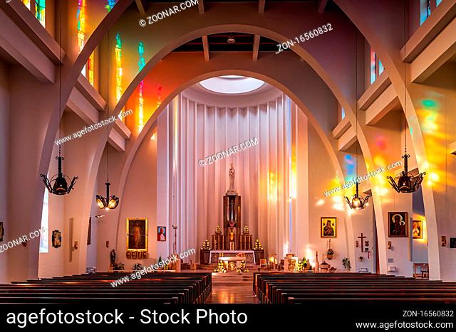 Szczecin Poland June 2019 Interior of Roman Catholic Church, Holy Family parish. Multicoloured light patterns from light shining through stained glass