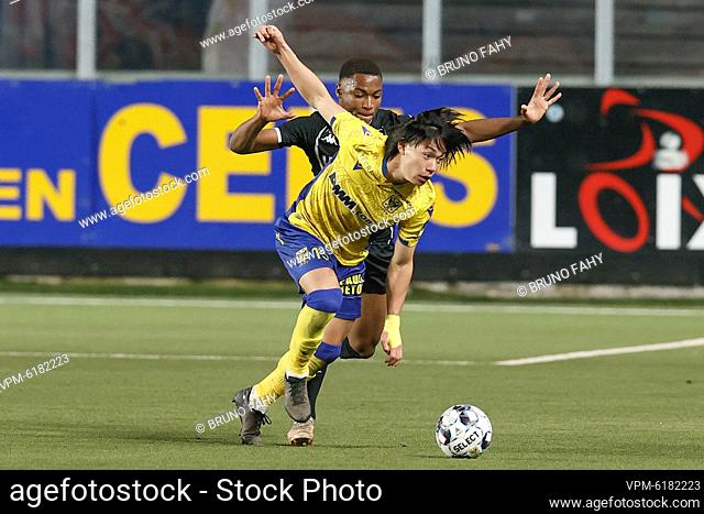 Charleroi's Loic Bessile and STVV's Daichi Hayashi fight for the ball during a soccer match between Sint-Truidense VV and Sporting Charleroi