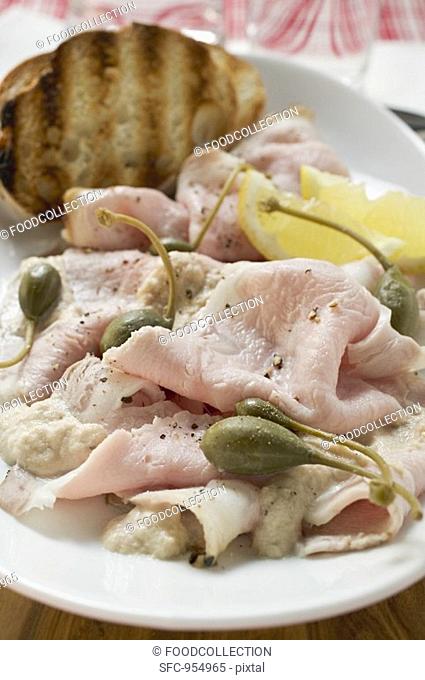 Cold roast pork with capers, lemon and toasted bread