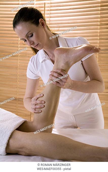 Wellness: man receiving leg massage