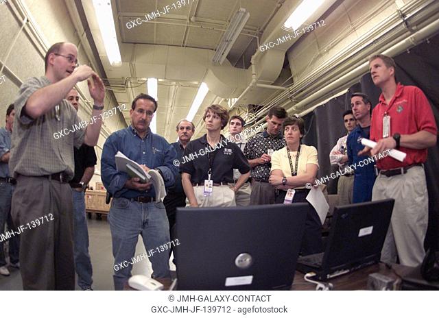 Instructor Adam DesLauriers (far left) with Neptec briefs STS-114 crewmembers on Shuttle tile scanning in the Antenna and Tracking Development Laboratory at...