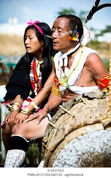 Naga tribal couple in traditional outfit with a drum, Hornbill Festival, Kohima, Nagaland, India