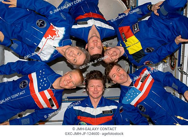 Expedition 20 crew members pose in star-burst formation for an in-flight portrait in the Harmony node of the International Space Station