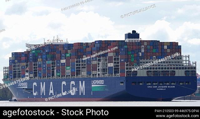 03 May 2021, Hamburg: The huge container ship ""CMA CGM Jacques Saade"" of the shipping company CMA CGM sails on the Elbe past the Teufelsbrück jetty towards...