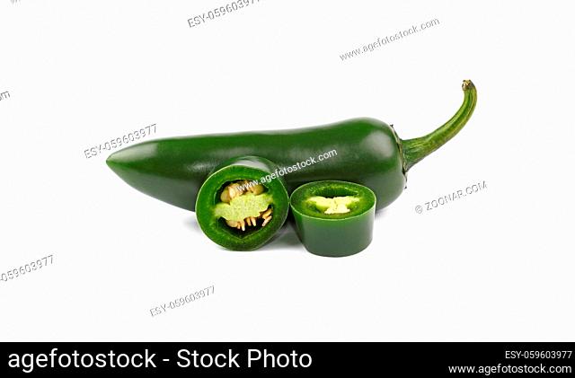 Close up one whole fresh green jalapeno hot chili pepper and two cut slices isolated on white background, low angle side view