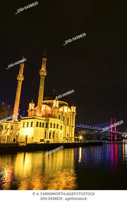 Istanbul, Turkey The Ortaköy Mosque under the Bosphorus Bridge, known officially as the 15 July Martyrs Bridge and unofficially as the First Bridge
