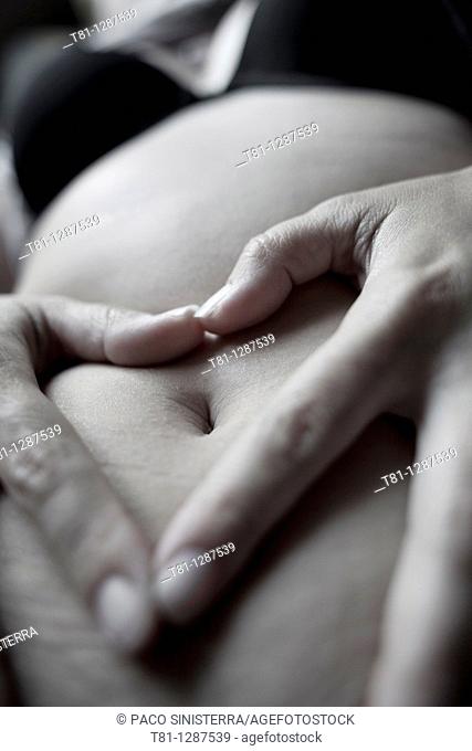 woman with hands on belly