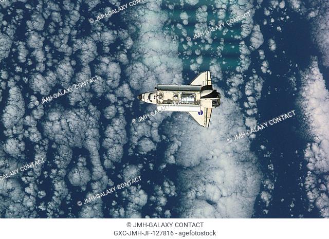 View of the Space Shuttle Discovery as it approaches the International Space Station (ISS) during the STS-105 mission. Aboard Discovery are the members of the...