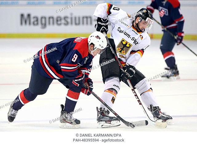 Germany's Tobias Rieder (R) in action against USA's Johnny Gaudreau during the ice hockey world cup friendly match between Germany and USA at the Arena in...