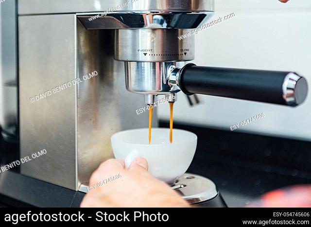 Detail of man's hands preparing an espresso